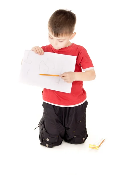 Pequeno menino mostra que desenha — Fotografia de Stock