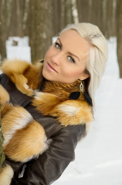 Sexy blond girl in the woods near a tree — Stock Photo, Image