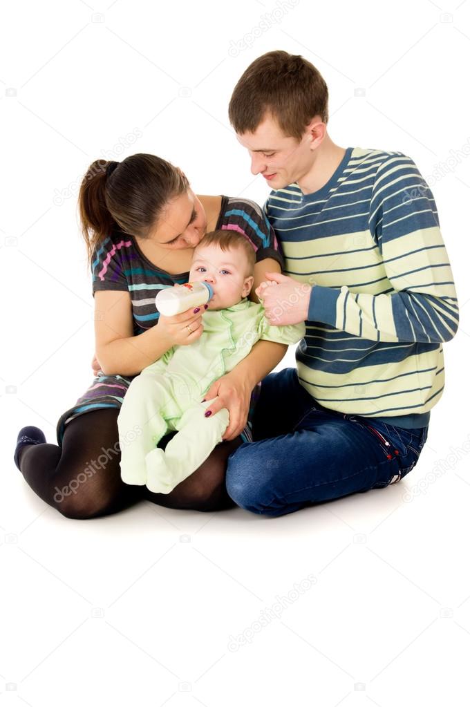 young the parents feeds baby