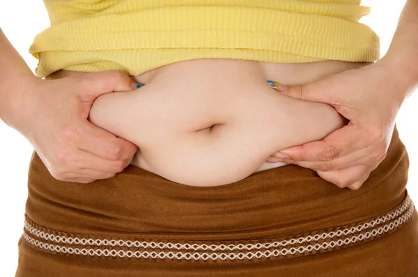 Dívka ukazuje břicho tuku — Stock fotografie