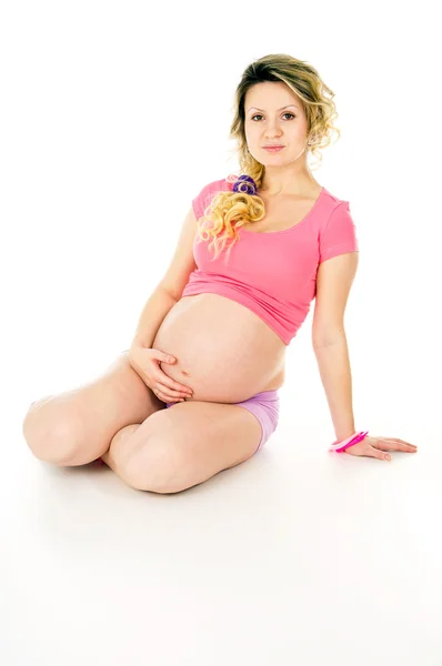 Pregnant girl sits — Stock Photo, Image