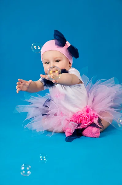 Baby and soap bubbles on a blue background — Stock Photo, Image