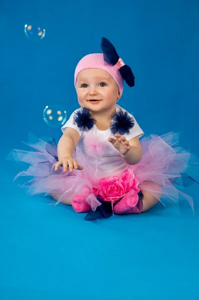 Baby and soap bubbles on a blue background — Stock Photo, Image