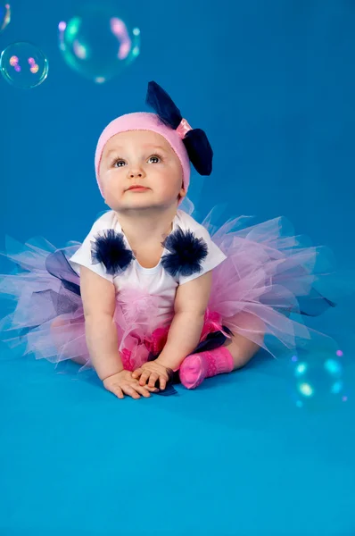 Baby and soap bubbles on a blue background Stock Photo