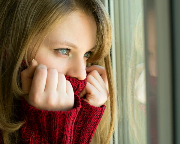 Ledsen tjej tittar ut genom fönstret som väntar på sin make — Stockfoto