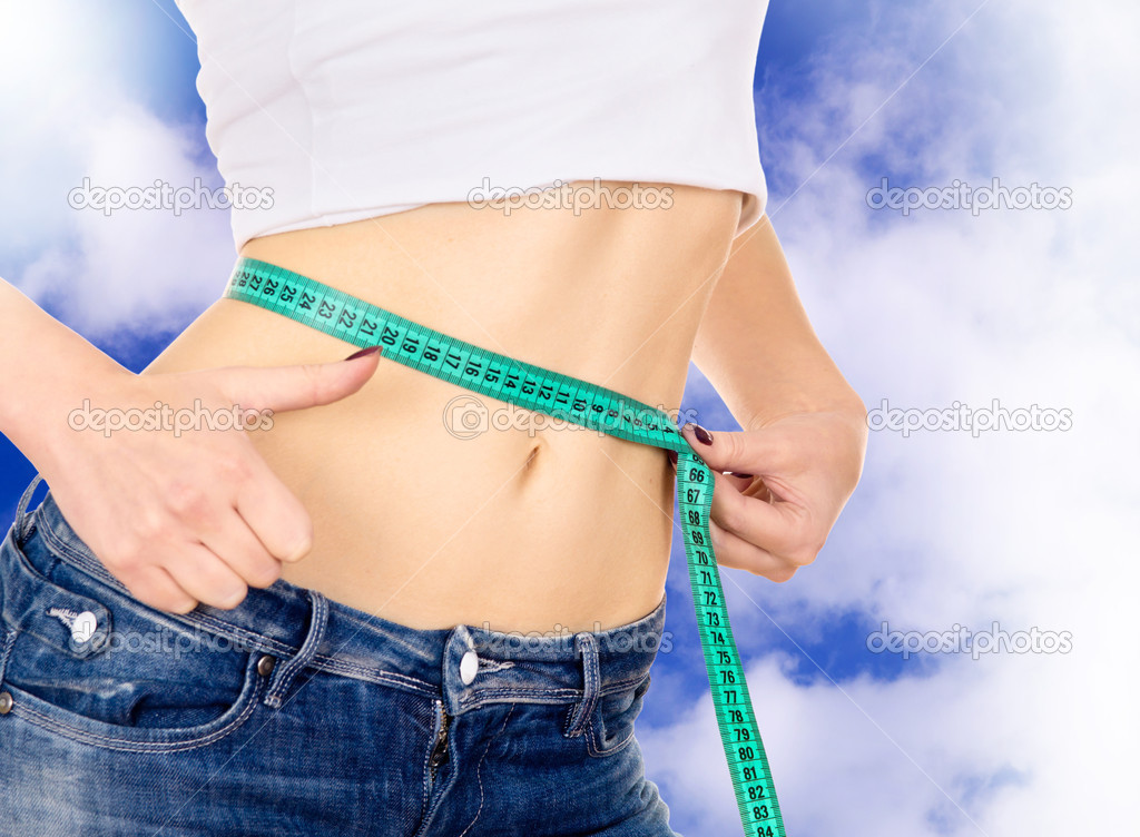 slim girl measure its waist and shows OK