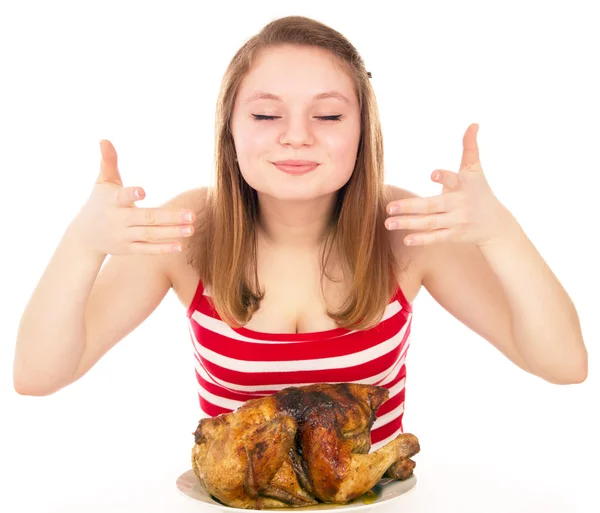 Beautiful girl  inhale the aroma of roasted chicken — Stock Photo, Image