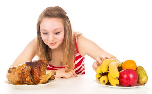 Beautiful girl eagerly looking for fried chicken — Stock Photo, Image