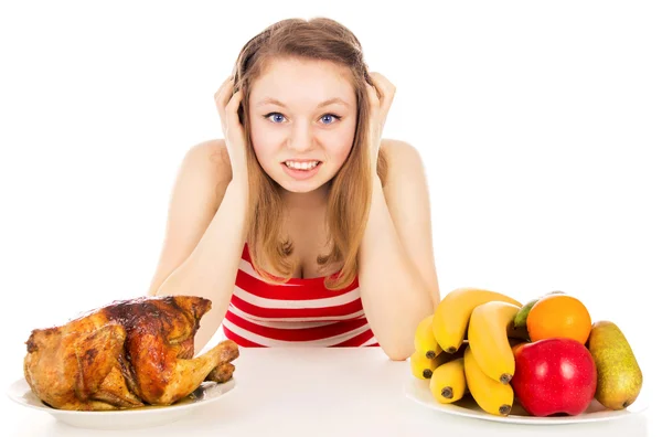Beautiful girl thinks before choosing food — Stock Photo, Image