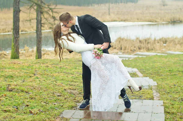 Beautiful husband and bride kiss — Stock Photo, Image