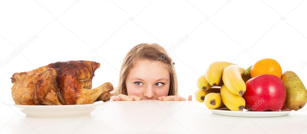 Beautiful girl peeking over the cooked chicken