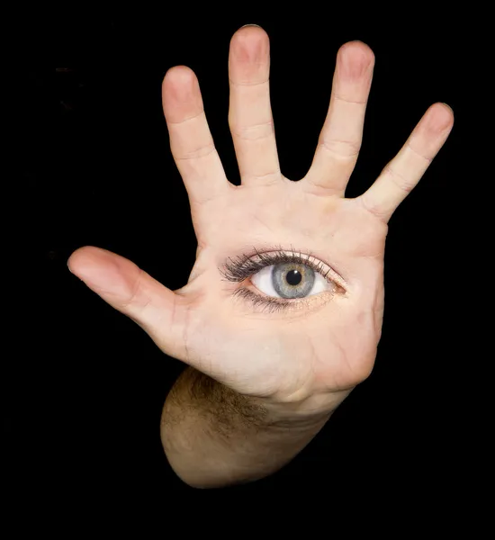 Occhio nella mano sullo sfondo nero — Foto Stock