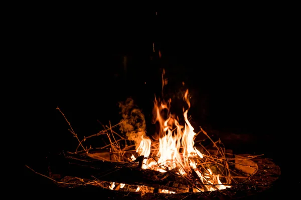 fire and flames. Flames and burning sparks close up, fire patterns. flames from the fire. Night bonfire, logs are on fire, sparks fly. soft focus.shallow focus effect.