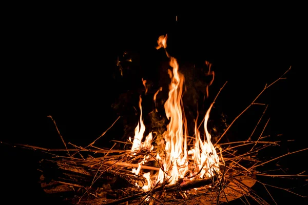 stock image fire and flames. Flames and burning sparks close up, fire patterns. flames from the fire. Night bonfire, logs are on fire, sparks fly. soft focus.shallow focus effect.