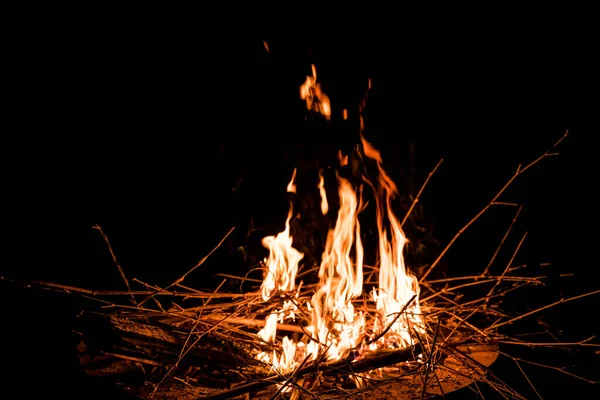 stock image fire and flames. Flames and burning sparks close up, fire patterns. flames from the fire. Night bonfire, logs are on fire, sparks fly. soft focus.shallow focus effect.