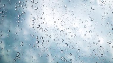 Rainwater drops Falling Down On the Window Glass, Rain Drops On The Windows Glass, and a Macro shot of water droplets falling.