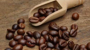 Dark Coffee beans on the old wooden floor,  Close up of seeds of coffee.