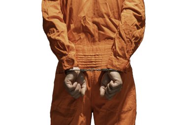 Handcuffs on Accused Criminal in Orange Jail Jumpsuit. Law Offender Sentenced to Serve Jail Time, in black background