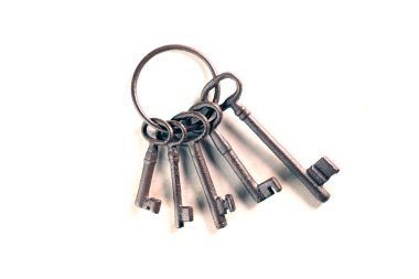 rusty bunch of old keys on white background, close up