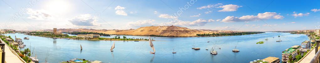 Full panorama of the Nile and sailboats by the banks of Aswan, Egypt