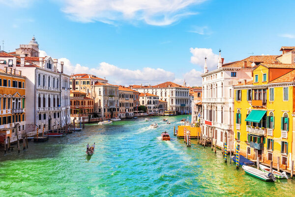 Channel of Venice with luxurious houses, gondolas and boats, Italy.