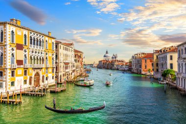 Gondoliers in the Grand Canal of Venice near Santa Maria della Salute, Italy.