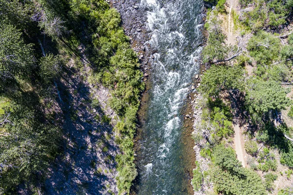 Whitewater rapids form waves in the fast flowing water of the Truckee river in California.