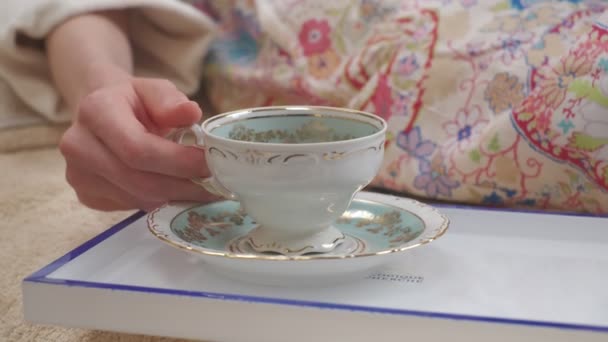 Close White Porcelain Cup Gold Ornaments Taken Saucer Woman Laying — Stock video