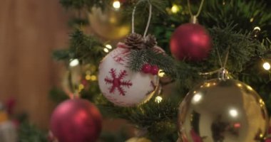 Closeup of toy balls hanging on christmas tree, slow motion