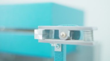 Closeup of polymer thread for plastic sack bags is installed to strength test machine