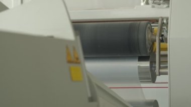 Closeup of polymer tape wending machine, slow motion