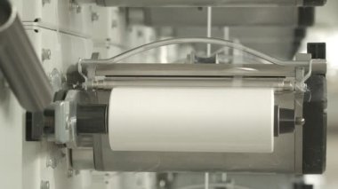 Closeup of polymer thread winding machine in action, slow motion