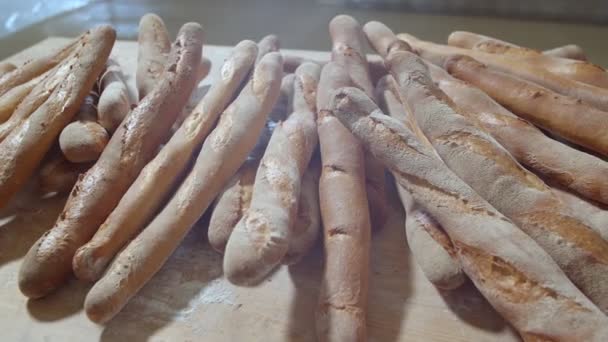 Fresh Baked Long Baguette Breads Lie Wooden Table Sprinkled Flour — Stockvideo