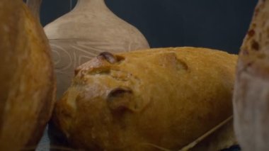 Close-up of fresh baked whole grain bread move in slow motion. Ready to eat
