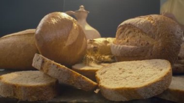 Close-up of fresh baked whole grain bread move in slow motion. Ready to eat