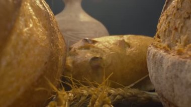 Close-up of fresh baked whole grain bread move in slow motion. Ready to eat