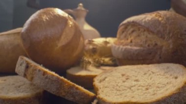Close-up of fresh baked whole grain bread move in slow motion. Ready to eat
