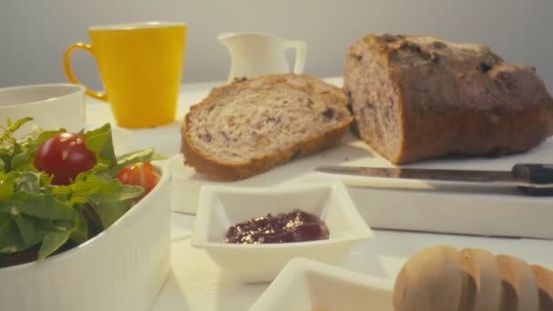 Zoom Out Sliced Rye Raisin Bread Whole White Dinner Table — ストック動画