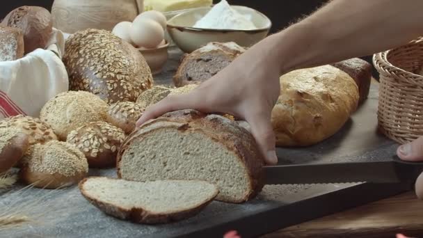 Male Hands Cutting Fresh Baked Dutch Bread Wooden Table Full — Vídeos de Stock
