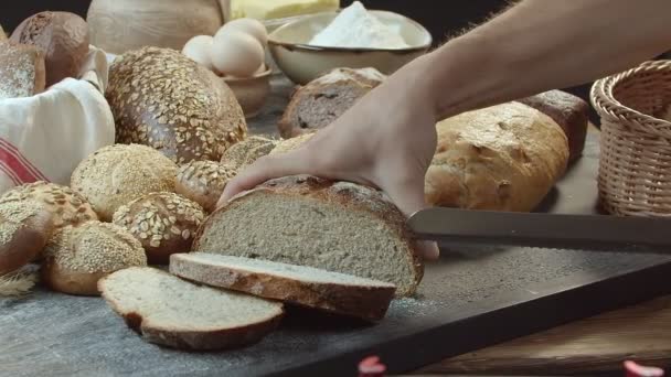 Male Hands Cutting Fresh Baked Dutch Bread Wooden Table Full — Vídeos de Stock