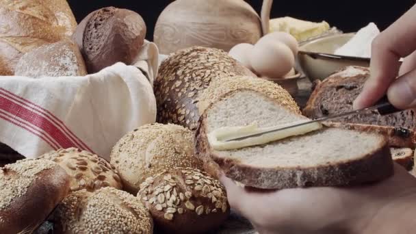 Male Hands Butter Piece Fresh Baked Dutch Bread Wooden Table — Stockvideo