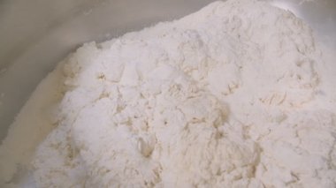 Container of big bakery mixer and mixer blades are cleaned of of dough residues. Slow motion