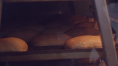 Pouring flour on a plastic tray in the bread factory