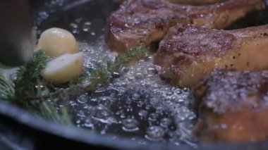 Small onions are thrown to the cast iron pan with lamb ribs fried in butter. Slow motion