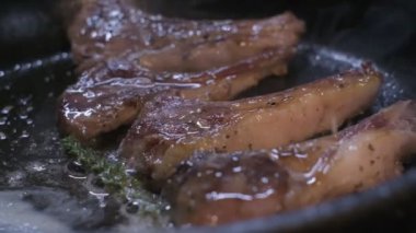 Small onions are thrown to the cast iron pan with lamb ribs fried in butter. Slow motion