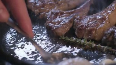 Small onions are thrown to the cast iron pan with lamb ribs fried in butter. Slow motion