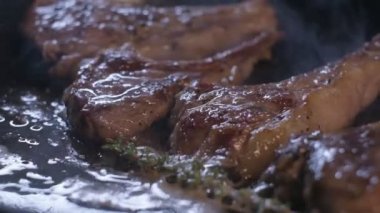 Small onions are thrown to the cast iron pan with lamb ribs fried in butter. Slow motion