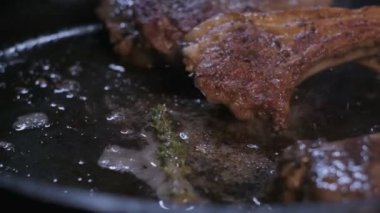 Small onions are thrown to the cast iron pan with lamb ribs fried in butter. Slow motion