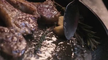 Small onions are thrown to the cast iron pan with lamb ribs fried in butter. Slow motion