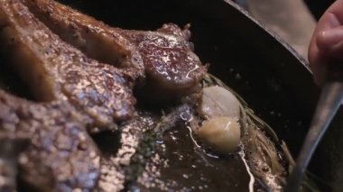Small onions are thrown to the cast iron pan with lamb ribs fried in butter. Slow motion